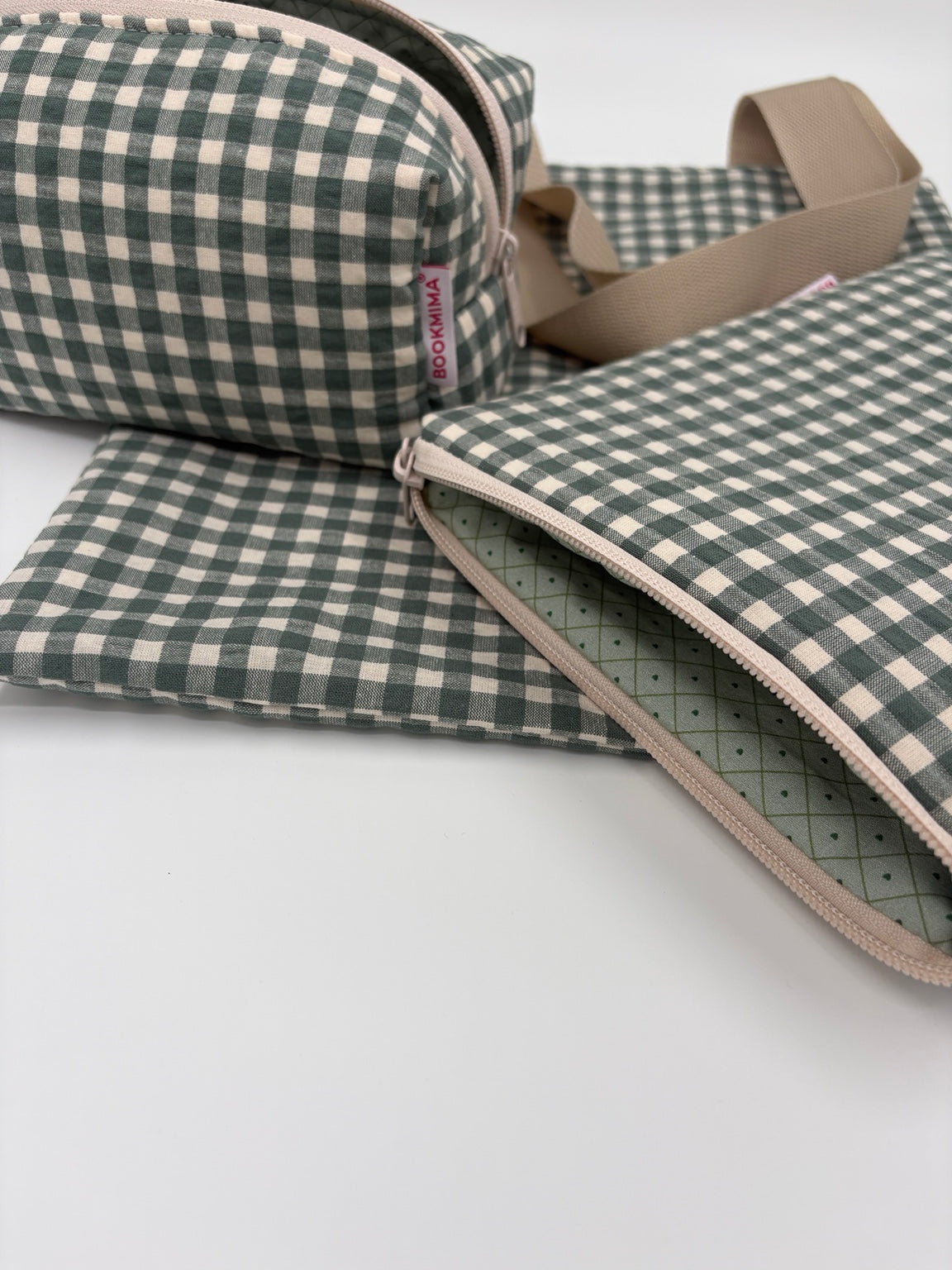 Detalle de la cremallera beige y el forro verde geométrico de la funda Oliva Bookmima